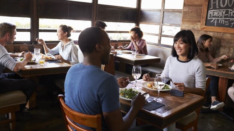 A group of people dining at a restaurant.