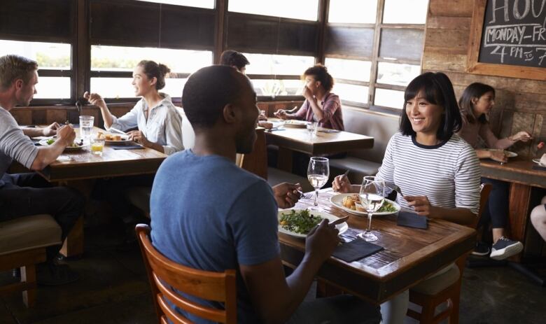 A group of people dining at a restaurant.