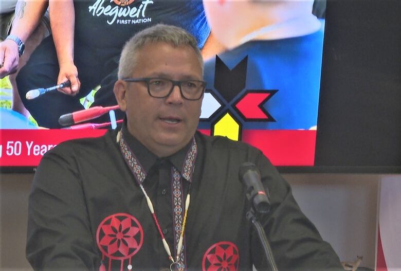 Abegweit First Nation Chief Junior Gould at podium.