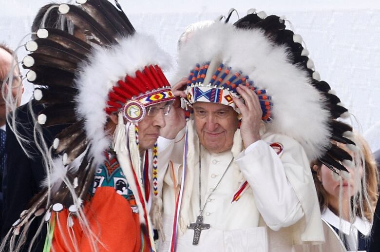 Pope Francis puts on a headdress