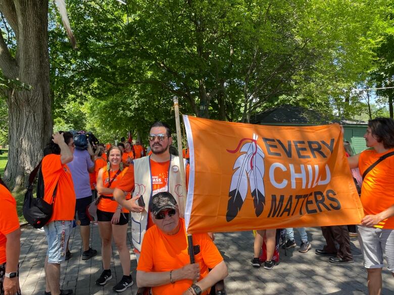 People are carrying a flag.