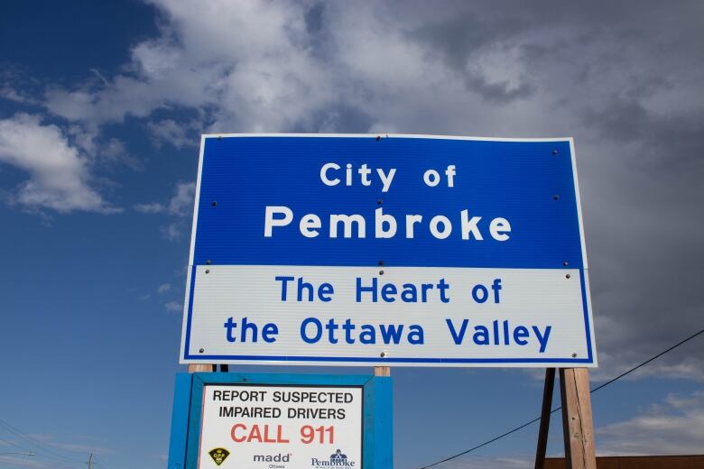 A blue-and-white sign for the city of Pembroke.