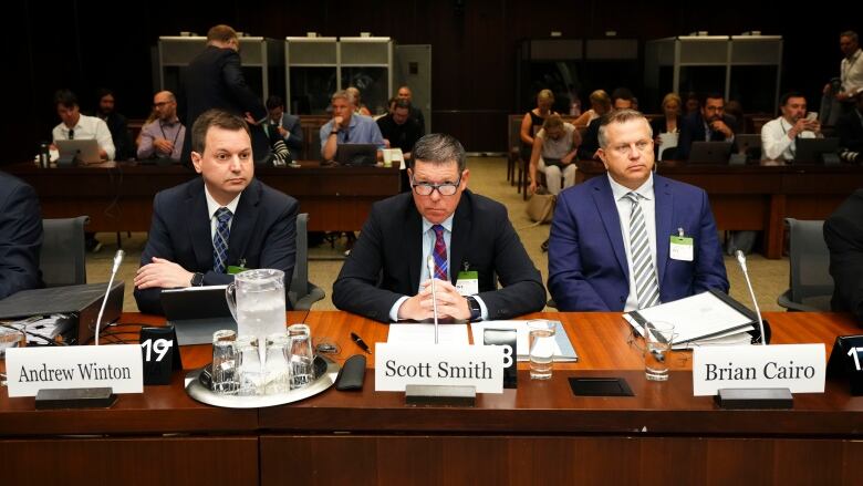 Lawyer Andrew Winton sits alongside Hockey Canada CEO Scott Smith, centre, and CFO Brian Cairo, right, during parliamentary hearings on Wednesday. Some parents say they're reconsidering enrolling their children in youth hockey programs after the revelation that the federation used those funds to pay off sexual assault settlements.