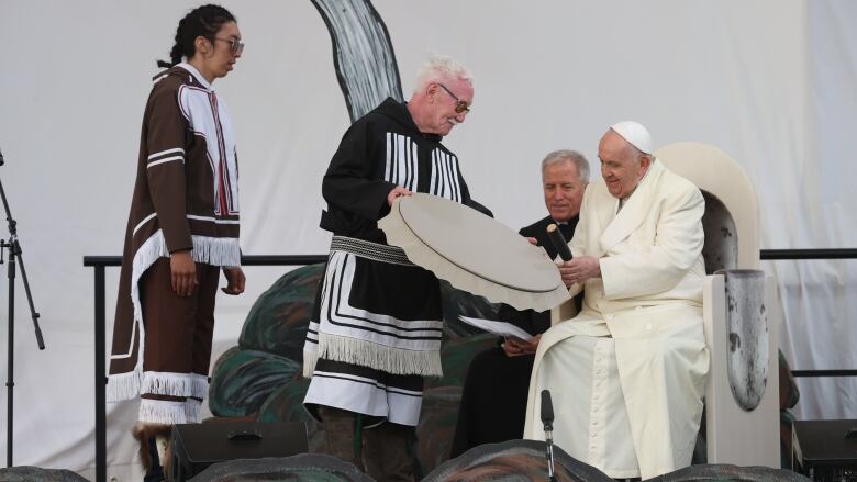 Residential school survivor Piita Irniq presents a handmade drum to Pope Francis in Iqaluit on July 29, 2022.