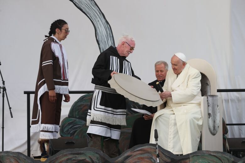 Residential school survivor Piita Irniq presents a handmade drum to Pope Francis in Iqaluit on July 29, 2022.