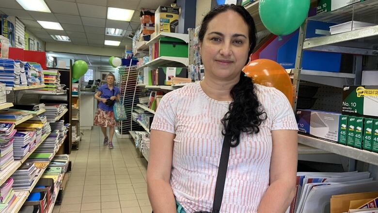 A woman stands in the aisle of a store