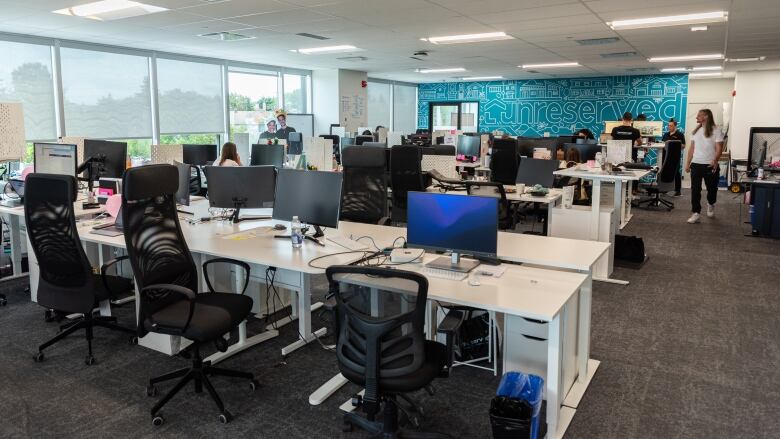 An office with a blue mural on the back wall.