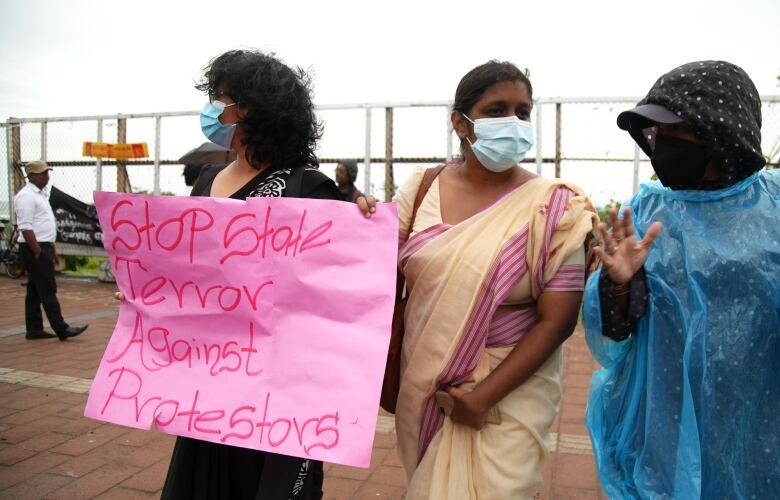 Three women protest the government in Sri Lanka.