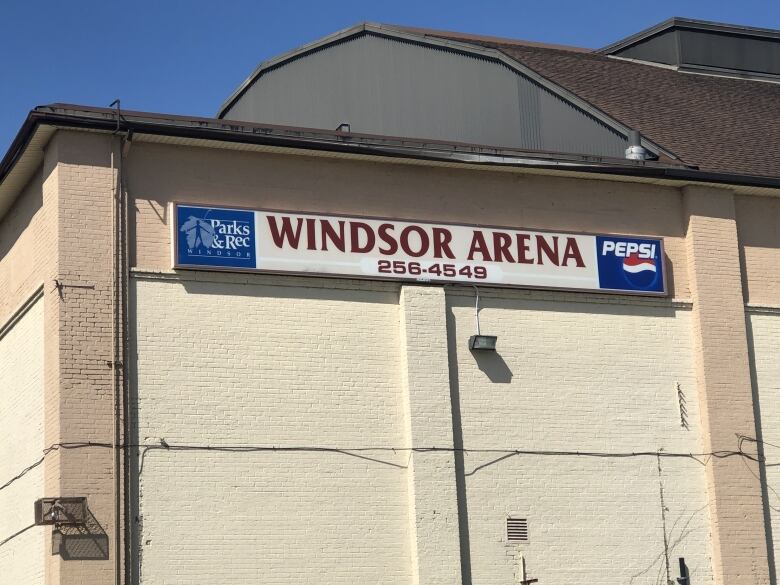 An old hockey arena with signs.