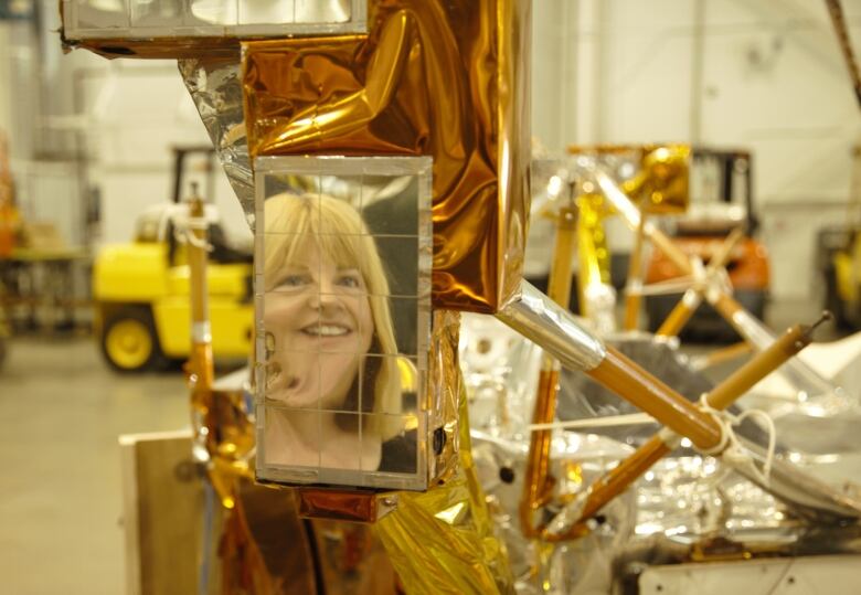 B.C. poet Donna Kane's face is shown reflected in the Pioneer 10 space craft during a visit to the Smithsonian Museum in Washington, D.C. 