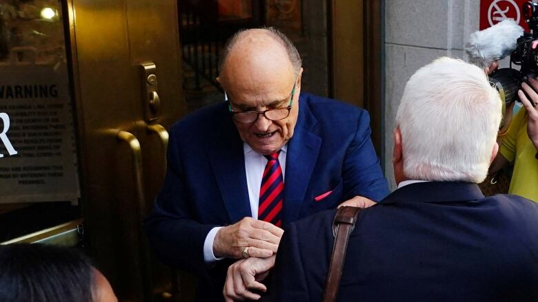 A man checks his watch.