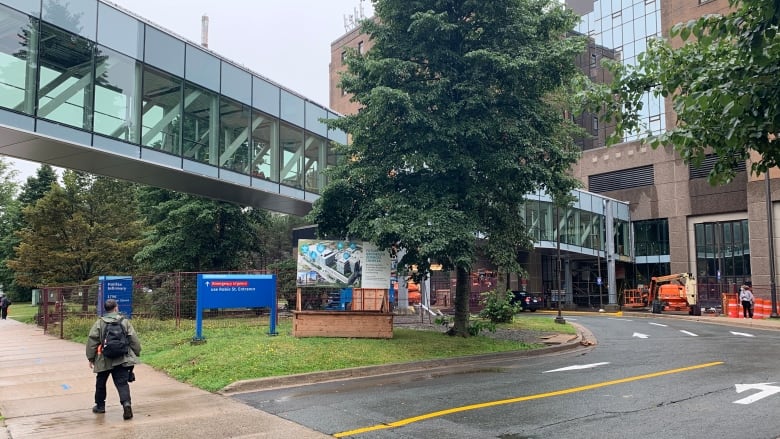 A person walks by a hospital.