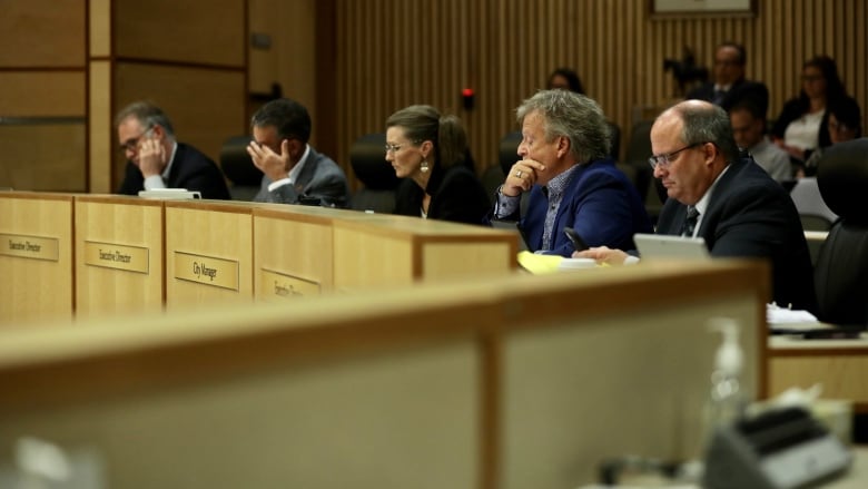 City solicitor Byron Werry, executive director of citizen services Kim Onrait, acting executive director of city planning Deborah Bryden and interim city manager Jim Nicol and executive director of financial strategy Barry Lacey take part in a Regina city council meeting on Aug. 17, 2022. 