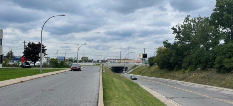 A street facing an overpass in the distance.  