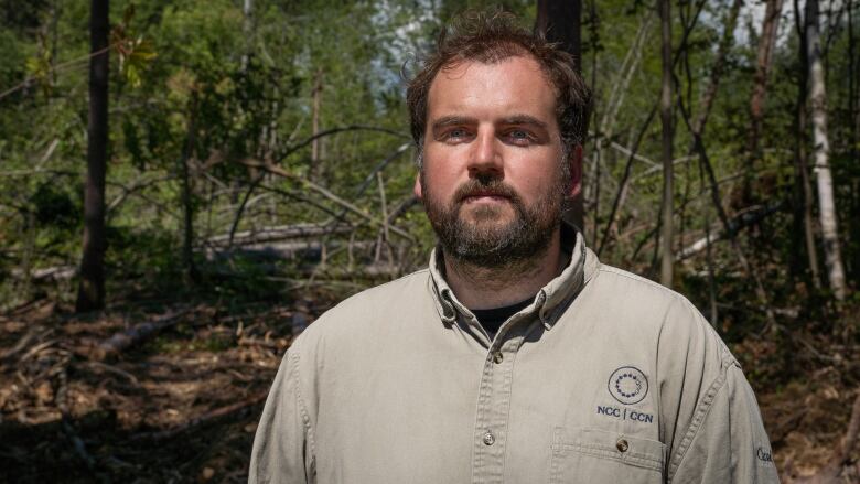 A man stands in the woods.