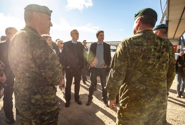 NATO Secretary General Jens Stoltenberg and Prime Minister Justin Trudeau speak with military members about the North Warning System Site in Cambridge Bay, Nunavut on Thursday, August 25, 2022.