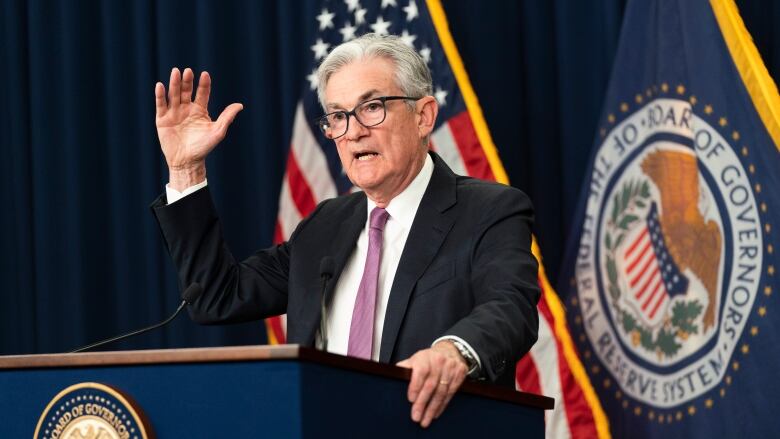 A man speaks at a government podium.