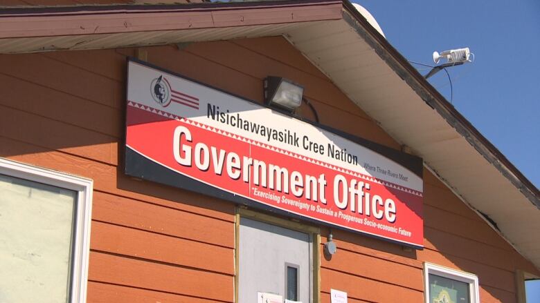 A sign hangs over the door of a First Nation community's local government offices.