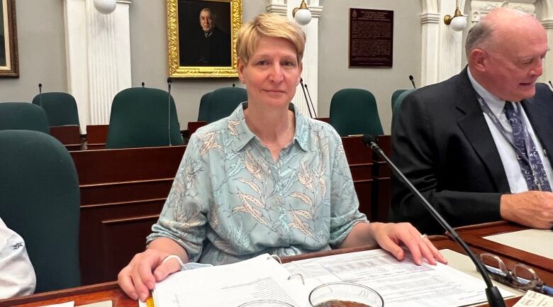 A woman sits in the Nova Scotia legislature.