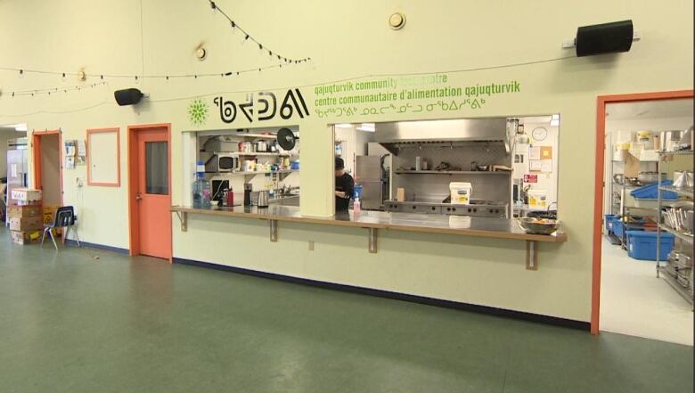 A kitchen can be seen from the inside of a community food centre.