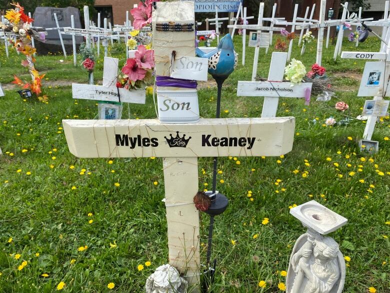 A white cross that has the name Myles Keaney on it.