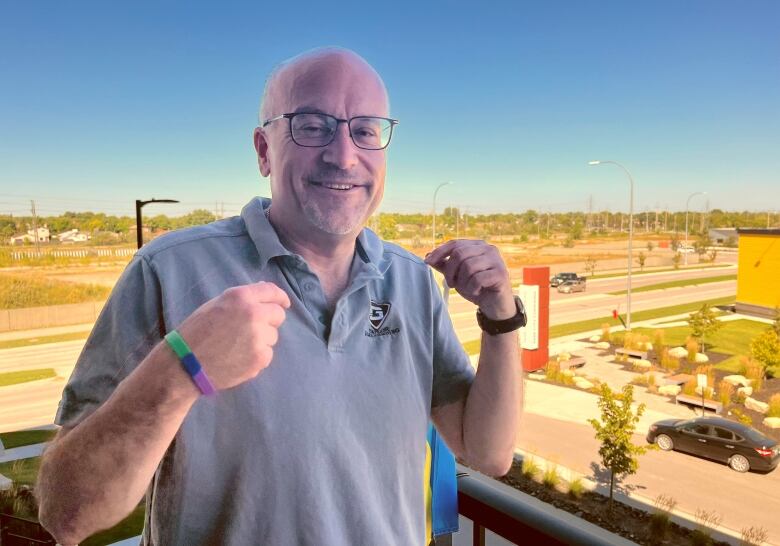 Russ Wyatt smiles and holds up two fists.