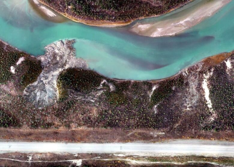 An aerial image of a landslide into a river.