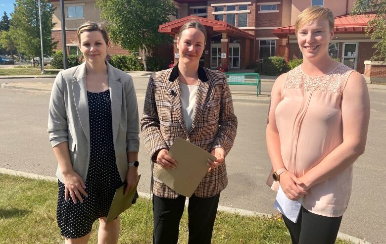 NDP MLAs Vicki Mowat and Jennifer Bowes stand with Kendal Carlberg in Meadow Lake, Sask., on Sept. 1, 2022. 