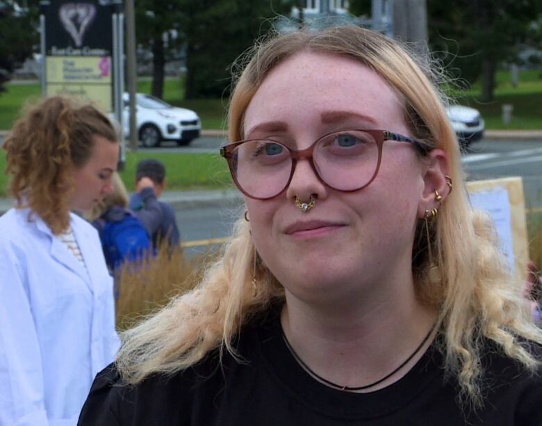 A young woman looks just slightly off the camera.