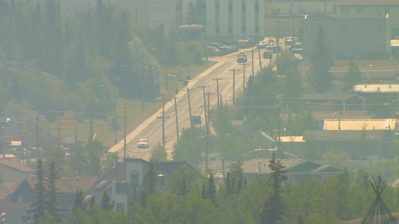 A road seen from above with a yellow haze covering entire image.