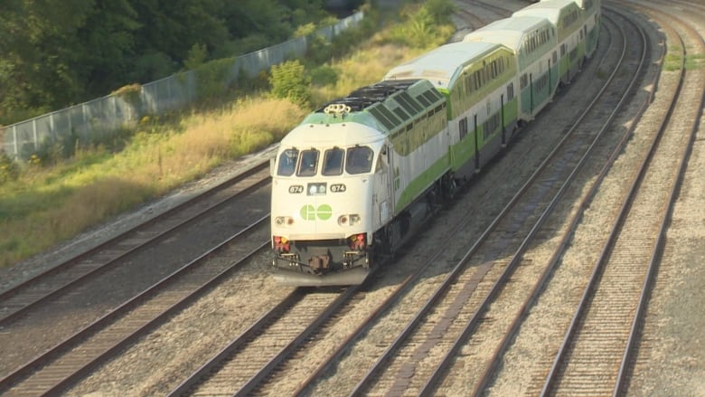 A GO train travelling on the tracks.