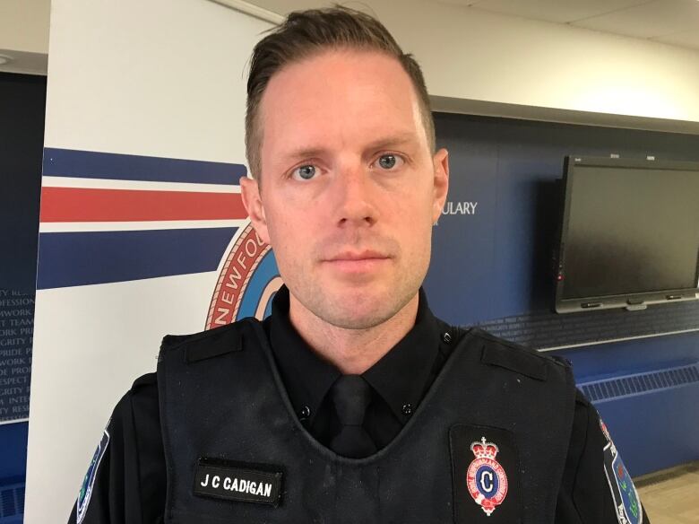 A police officer stands in uniform.