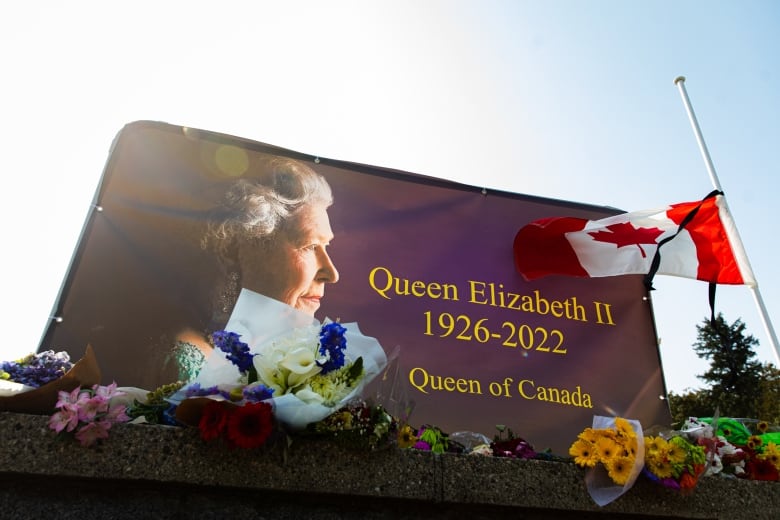 A sign that reads 'Queen Elizabeth II, 1926-2022, Queen of Canada'.