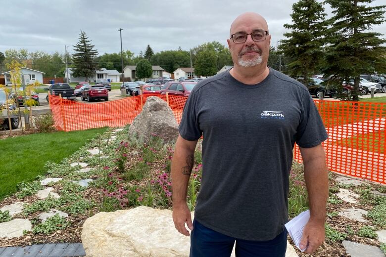 A man stands in front of the outdoor classroom.