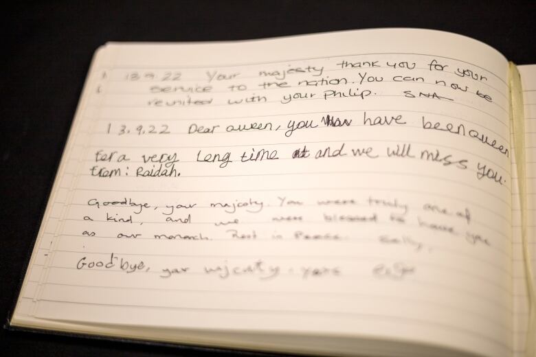 Writing in a book of condolence, which says Dear Queen. You have been Queen for a very long time and we will miss you.