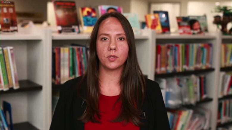 Woman standing in front of book shelf