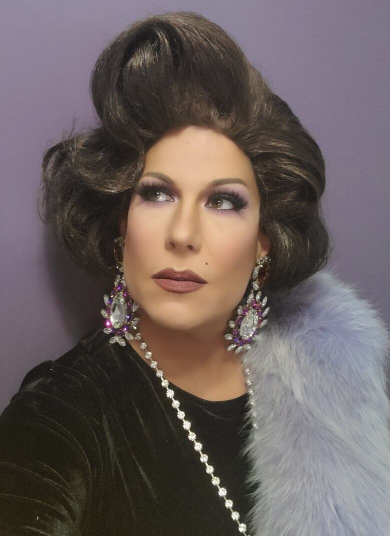 A drag performer poses for a photo.