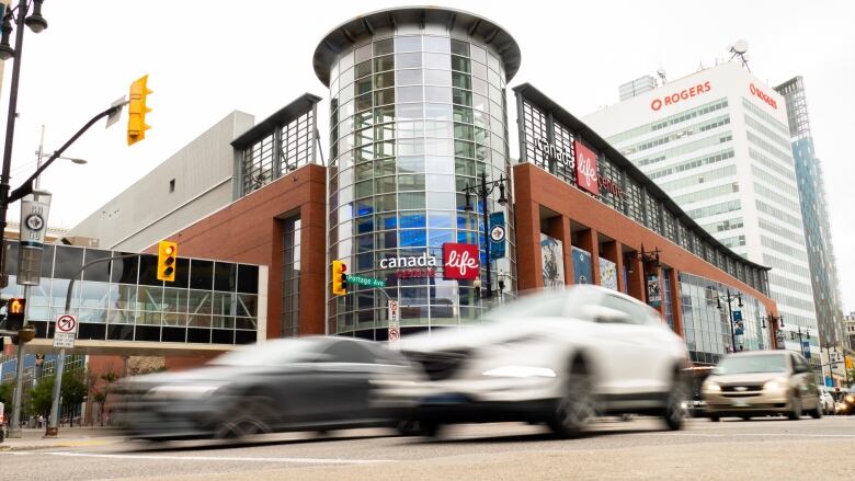 Vehicle driving in front of Canada Life Centre in downtown Winnipeg.