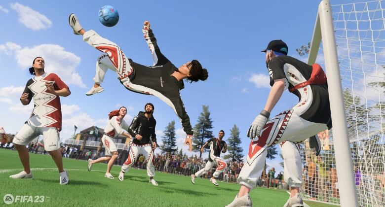 A soccer player in a video game performs an overhead kick as other players wearing Musqueam inspired uniforms look on.