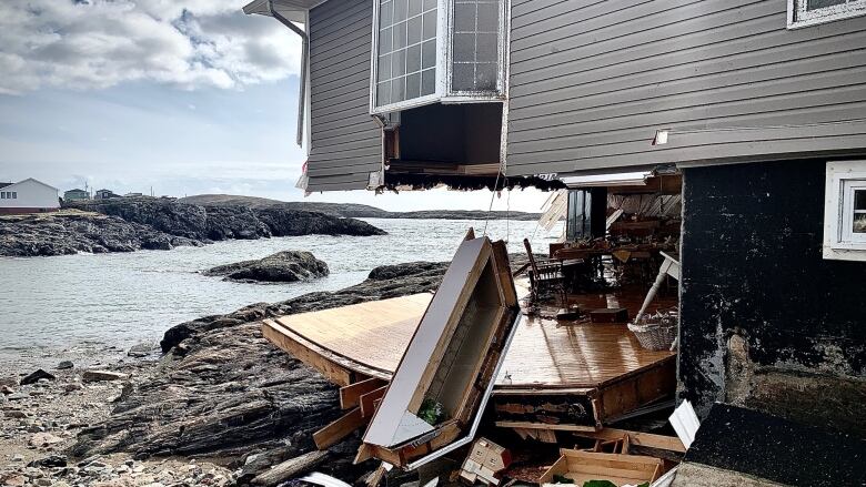 A house destroyed by a tropical storm near the water.