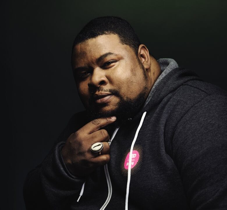 Michael Twitty poses with hand on chin for a picture