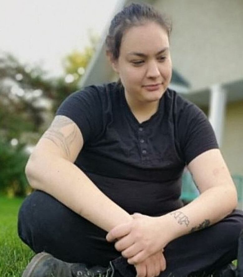 A woman poses for a photo.