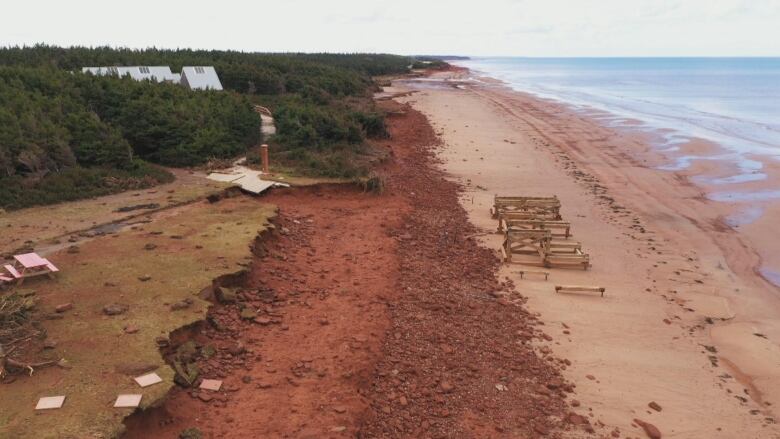 An overhead shot showing destruction on a red sand beach