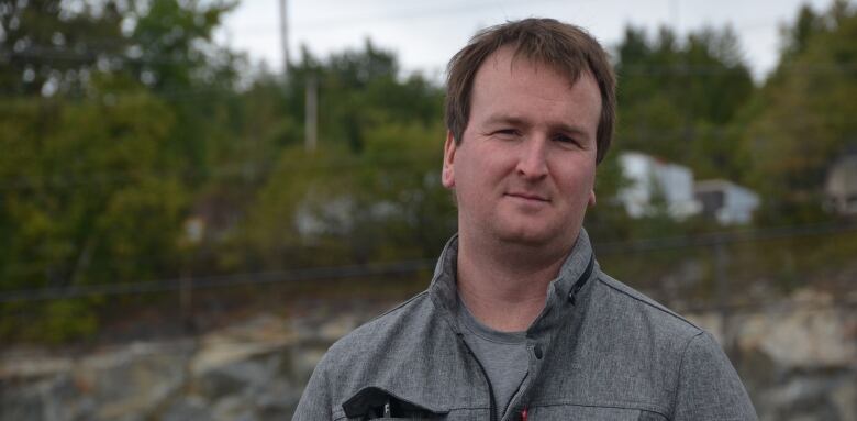 Michael Sanders stands near the Kingsway in Sudbury, wearing a grey jacket. 