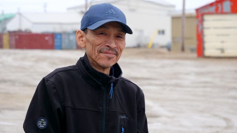 A portrait of a man outside.