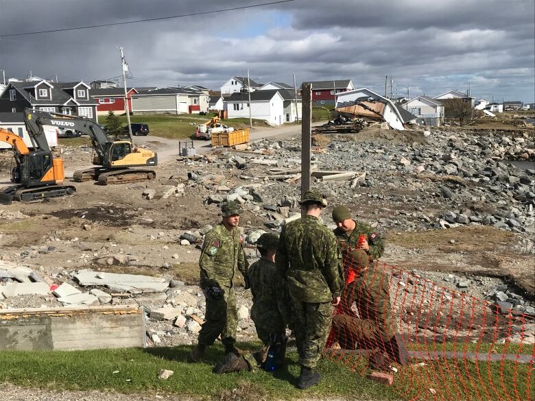 Members of the Canadian Forces set up an orange fence to keep the public away from debris caused by post-topical storm Fiona.