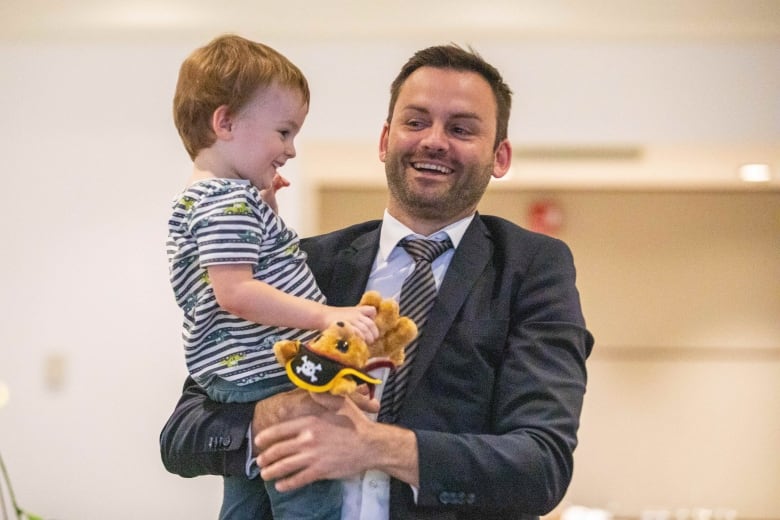 Parti Qubcois Leader Paul St-Pierre Plamondon holds his son Maurice during election night in Boucherville, Que. on Monday, Oct. 3, 2022. 