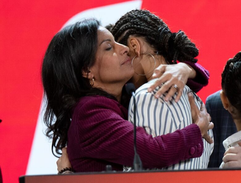 Quebec Liberal Leader Dominique Anglade hugs her daughter, Clara, after speaking to supporters after the results in the provincial election at the PLQ headquarters, in Montreal, Monday, Oct. 3, 2022.