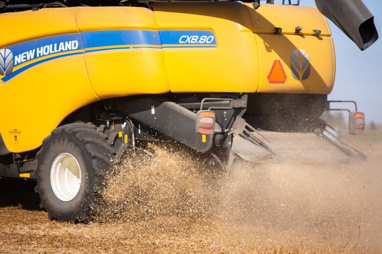 Debris spits out of a combine during the harvest.