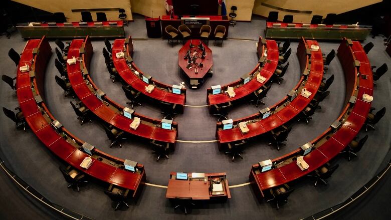 A drone image taken inside an empty city council chambers.